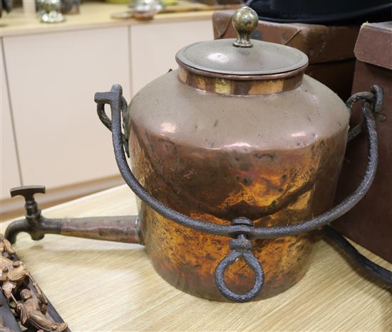 A large 19th century copper hot water urn with wrought iron pot hanger
